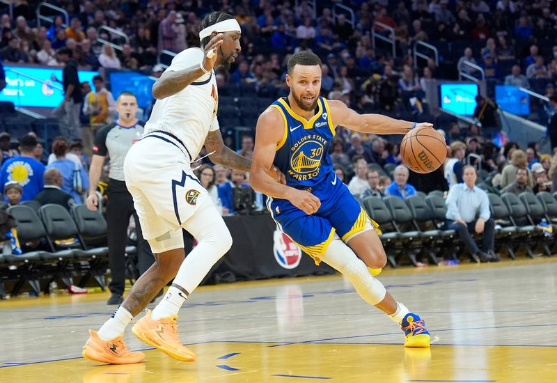 SAN FRANCISCO, CALIFORNIA - FEBRUARY 25: Stephen Curry #30 of the Golden State Warriors drives to the basket on Kentavious Caldwell-Pope #5 of the Denver Nuggets in the third quarter of an NBA basketball game at Chase Center on February 25, 2024 in San Francisco, California. NOTE TO USER: User expressly acknowledges and agrees that, by downloading and or using this photograph, User is consenting to the terms and conditions of the Getty Images License Agreement. (Photo by Thearon W. Henderson/Getty Images)