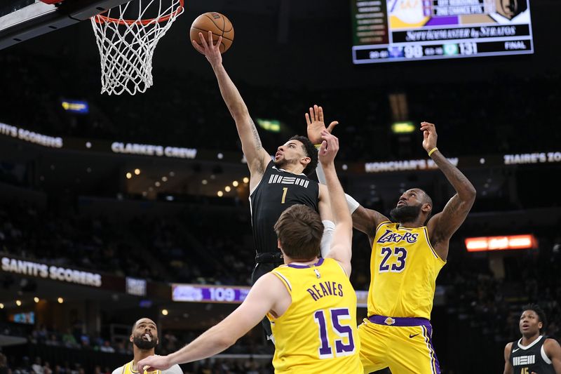 MEMPHIS, TENNESSEE - APRIL 12: Scotty Pippen Jr. #1 of the Memphis Grizzlies goes to the basket against LeBron James #23 of the Los Angeles Lakers during the second half at FedExForum on April 12, 2024 in Memphis, Tennessee. NOTE TO USER: User expressly acknowledges and agrees that, by downloading and or using this photograph, User is consenting to the terms and conditions of the Getty Images License Agreement. (Photo by Justin Ford/Getty Images)