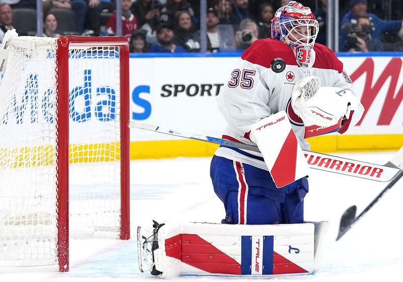 Oct 8, 2025; Toronto, Ontario, CAN; Montreal Canadiens goaltender Sam Montembeault (35) stops a puck against the Toronto Maple Leafs during the third period at Scotiabank Arena. Mandatory Credit: Nick Turchiaro-Imagn Images