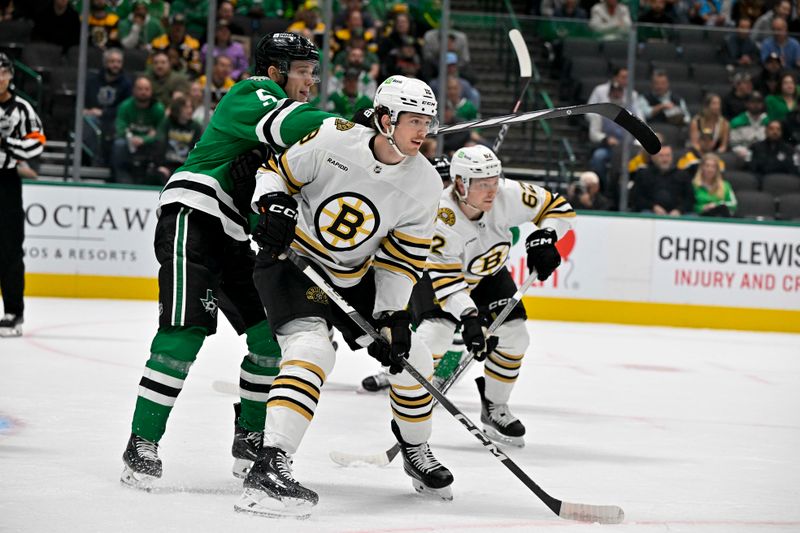 Nov 6, 2023; Dallas, Texas, USA; Dallas Stars defenseman Nils Lundkvist (5) and Boston Bruins center Johnny Beecher (19) look for the puck during the first period at the American Airlines Center. Mandatory Credit: Jerome Miron-USA TODAY Sports