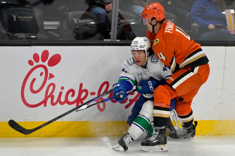 Nov 5, 2024; Anaheim, California, USA; Vancouver Canucks left wing Kiefer Sherwood (44) and Anaheim Ducks left wing Ross Johnston (44) battle along the boards in the second period at Honda Center. Mandatory Credit: Jayne Kamin-Oncea-Imagn Images