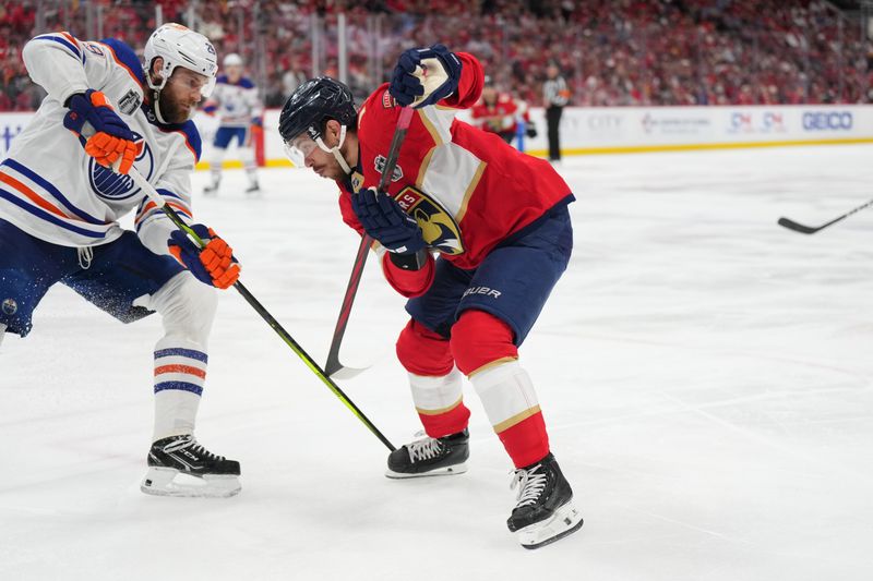 Jun 18, 2024; Sunrise, Florida, USA; Florida Panthers forward Evan Rodrigues (17) battles for the puck against Edmonton Oilers forward Leon Draisaitl (29) during the second period in game five of the 2024 Stanley Cup Final at Amerant Bank Arena. Mandatory Credit: Jim Rassol-USA TODAY Sports