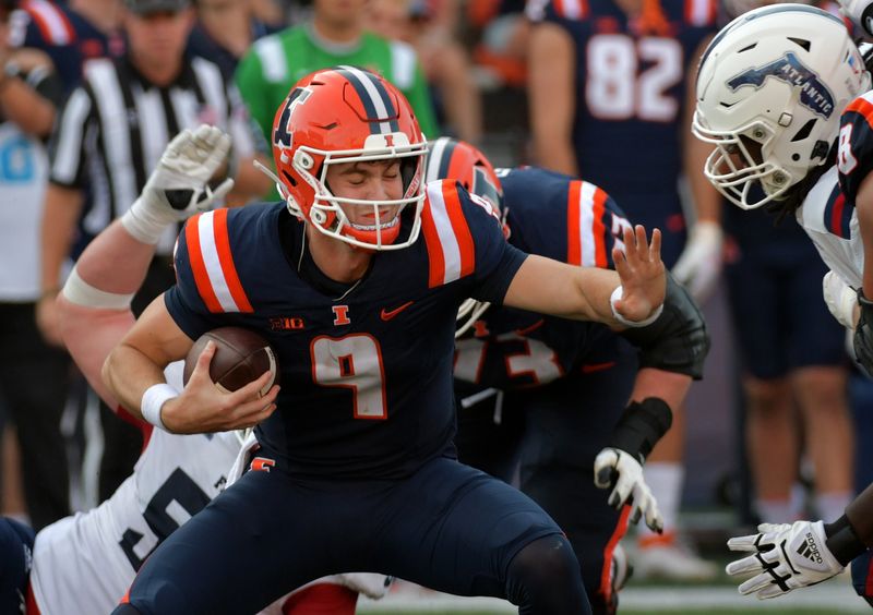 Sep 23, 2023; Champaign, Illinois, USA;  Illinois Fighting Illini quarterback Luke Altmyer (9) tries to fight off a sack during the second half against the Florida Atlantic Owls at Memorial Stadium. Mandatory Credit: Ron Johnson-USA TODAY Sports