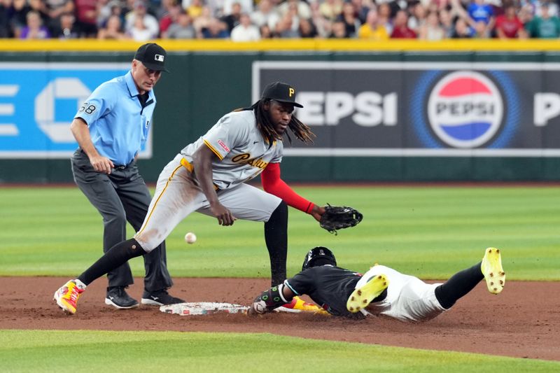 Jul 27, 2024; Phoenix, Arizona, USA; Arizona Diamondbacks shortstop Geraldo Perdomo (2) slides into second base safely as a throw gets away from Pittsburgh Pirates shortstop Oneil Cruz (15) during the second inning at Chase Field. Mandatory Credit: Joe Camporeale-USA TODAY Sports