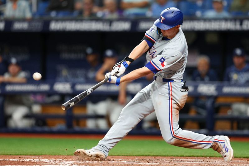 Apr 3, 2024; St. Petersburg, Florida, USA;  Texas Rangers designated hitter Corey Seager (5) hits a solo home run against the Tampa Bay Rays in the sixth inning at Tropicana Field. Mandatory Credit: Nathan Ray Seebeck-USA TODAY Sports