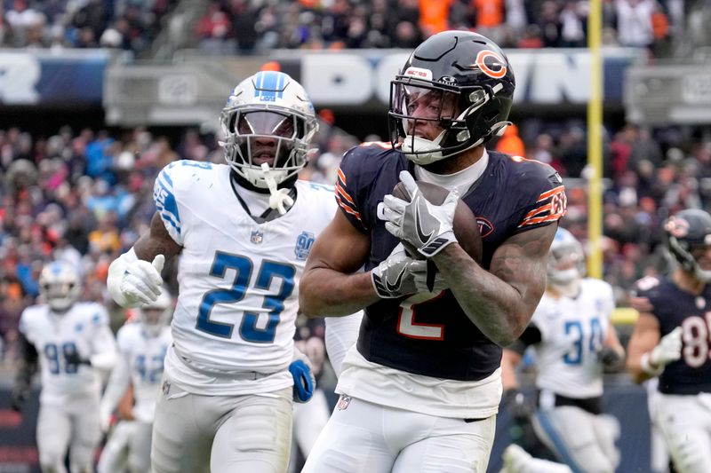 Chicago Bears wide receiver DJ Moore catches a touchdown pass from quarterback Justin Fields, as Detroit Lions cornerback Jerry Jacobs watches during the second half of an NFL football game against the Detroit Lions Sunday, Dec. 10, 2023, in Chicago. (AP Photo/Nam Y. Huh)