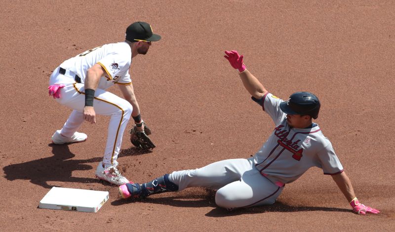 May 11, 2025; Pittsburgh, Pennsylvania, USA;  Atlanta Braves catcher Drake Baldwin (30) slides into second base with a double as Pittsburgh Pirates shortstop Jared Triolo (19) takes a late throw during the fourth inning at PNC Park. Mandatory Credit: Charles LeClaire-Imagn Images