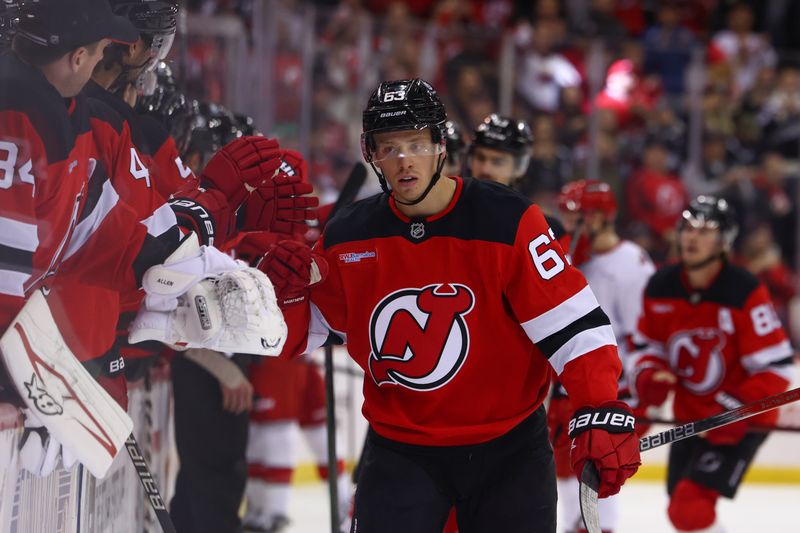 Nov 21, 2024; Newark, New Jersey, USA; New Jersey Devils left wing Jesper Bratt (63) celebrates his goal against the Carolina Hurricanes during the third period at Prudential Center. Mandatory Credit: Ed Mulholland-Imagn Images