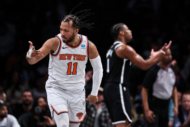 NEW YORK, NEW YORK - JANUARY 23: Jalen Brunson #11 of the New York Knicks reacts after making a three pointer during the second quarter of the game against the Brooklyn Nets at Barclays Center on January 23, 2024 in New York City.  NOTE TO USER: User expressly acknowledges and agrees that, by downloading and or using this photograph, User is consenting to the terms and conditions of the Getty Images License Agreement. (Photo by Dustin Satloff/Getty Images)