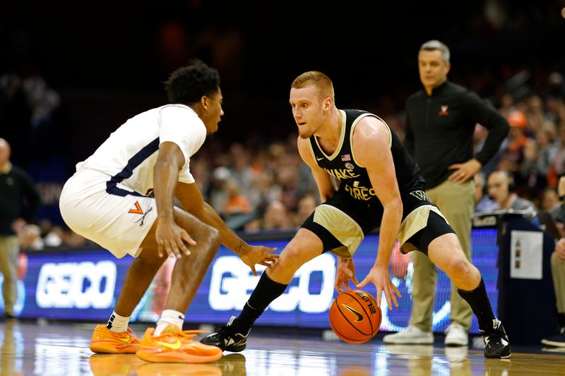 Feb 17, 2024; Charlottesville, Virginia, USA; Wake Forest Demon Deacons guard Cameron Hildreth (2) dribbles the ball as Virginia Cavaliers guard Reece Beekman (2) defends in the first half at John Paul Jones Arena. Mandatory Credit: Geoff Burke-USA TODAY Sports