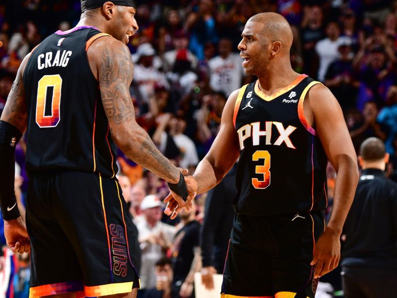 PHOENIX, AZ - APRIL 16:  Chris Paul #3 & Torrey Craig #0 of the Phoenix Suns high fives during the game During round one game one of the 2023 NBA Playoffs on April 16, 2023 at Footprint Center in Phoenix, Arizona. NOTE TO USER: User expressly acknowledges and agrees that, by downloading and or using this photograph, user is consenting to the terms and conditions of the Getty Images License Agreement. Mandatory Copyright Notice: Copyright 2023 NBAE (Photo by Barry Gossage/NBAE via Getty Images)