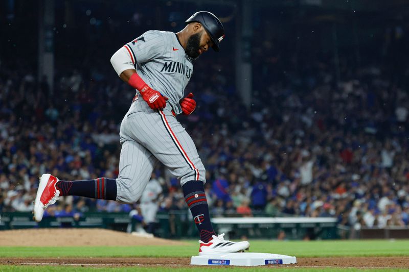 Aug 5, 2024; Chicago, Illinois, USA; Minnesota Twins outfielder Manuel Margot (13) rounds the bases after hitting a solo home run against the Chicago Cubs during the fifth inning at Wrigley Field. Mandatory Credit: Kamil Krzaczynski-USA TODAY Sports