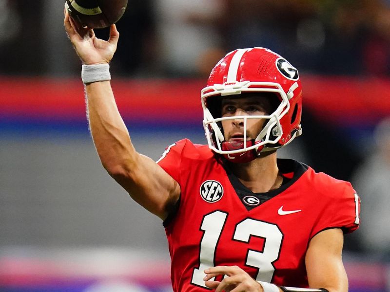 Sep 3, 2022; Atlanta, Georgia, USA; Georgia Bulldogs quarterback Stetson Bennett (13) rolls out to pass against the Oregon Ducks  during the first quarter of the Chick-fil-A kickoff game at Mercedes-Benz Stadium. Mandatory Credit: John David Mercer-USA TODAY Sports