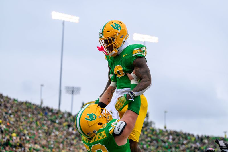 Oct 21, 2023; Eugene, Oregon, USA; Oregon Ducks running back Bucky Irving (0) celebrates a touchdown with offensive lineman Jackson Powers-Johnson (58) in the second quarter against the Washington State Cougars at Autzen Stadium. Mandatory Credit: Craig Strobeck-USA TODAY Sports