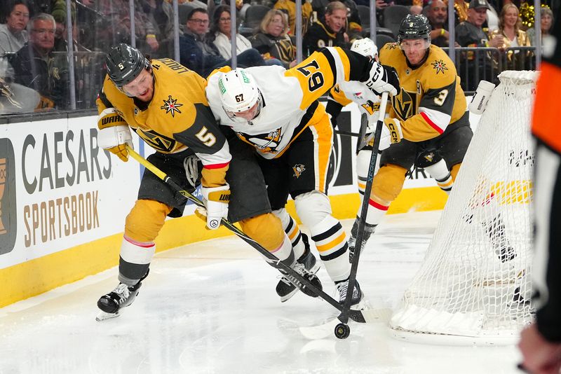 Mar 12, 2026; Las Vegas, Nevada, USA; Pittsburgh Penguins right wing Rickard Rakell (67) pushes the puck ahead of the stick of Vegas Golden Knights defenseman Jeremy Lauzon (5) during the second period at T-Mobile Arena. Mandatory Credit: Stephen R. Sylvanie-Imagn Images