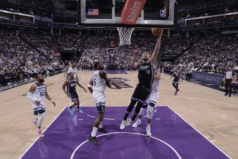 SACRAMENTO, CA - OCTOBER 24: Domantas Sabonis #11 of the Sacramento Kings drives to the basket during the game against the Minnesota Timberwolves on October 24, 2024 at Golden 1 Center in Sacramento, California. NOTE TO USER: User expressly acknowledges and agrees that, by downloading and or using this Photograph, user is consenting to the terms and conditions of the Getty Images License Agreement. Mandatory Copyright Notice: Copyright 2024 NBAE (Photo by Rocky Widner/NBAE via Getty Images)