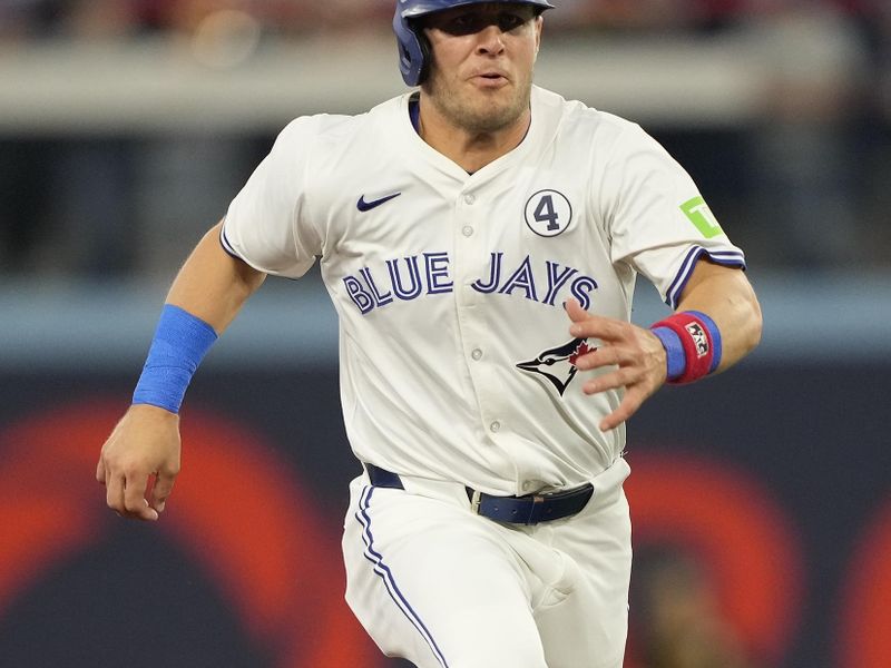 Jun 2, 2024; Toronto, Ontario, CAN; Toronto Blue Jays center fielder Daulton Varsho (25) heads to third base during the third inning against the Pittsburgh Pirates at Rogers Centre. Mandatory Credit: John E. Sokolowski-USA TODAY Sports