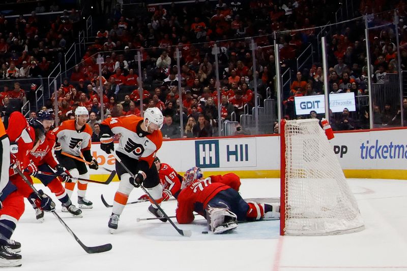 Mar 1, 2024; Washington, District of Columbia, USA; Washington Capitals goaltender Charlie Lindgren (79) makes a save on Philadelphia Flyers center Sean Couturier (14) in the third period at Capital One Arena. Mandatory Credit: Geoff Burke-USA TODAY Sports