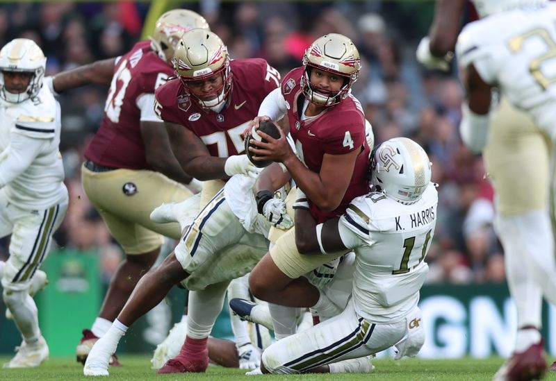 Aug 24, 2024; Dublin, IRL; Georgia Tech defensive lineman Kevin Harris II tackles Florida State University quarterback DJ Uiagalelei at Aviva Stadium. Mandatory Credit: Tom Maher/INPHO via USA TODAY Sports