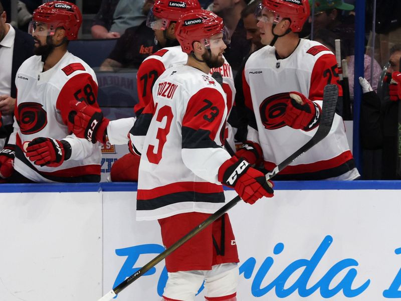 Sep 26, 2025; Tampa, Florida, USA; Carolina Hurricanes left wing Gleb Trikozov (73) is congratulated after he scored a goal against the Tampa Bay Lightning during the third period at Benchmark International Arena. Mandatory Credit: Kim Klement Neitzel-Imagn Images