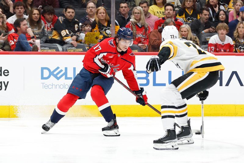 Apr 4, 2024; Washington, District of Columbia, USA; Washington Capitals center Dylan Strome (17) skates with the puck as Pittsburgh Penguins defenseman Pierre-Olivier Joseph (73) defends in the third period at Capital One Arena. Mandatory Credit: Geoff Burke-USA TODAY Sports