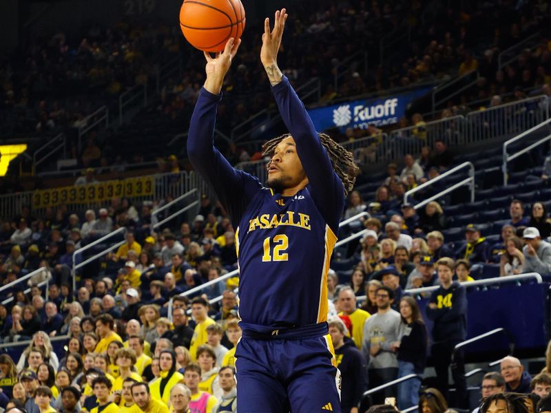Dec 21, 2025; Ann Arbor, Michigan, USA; La Salle Explorers guard Damon Strand (12) shoots a three point shot during the second half against the Michigan Wolverine at Crisler Center. Mandatory Credit: Brian Bradshaw Sevald-Imagn Images