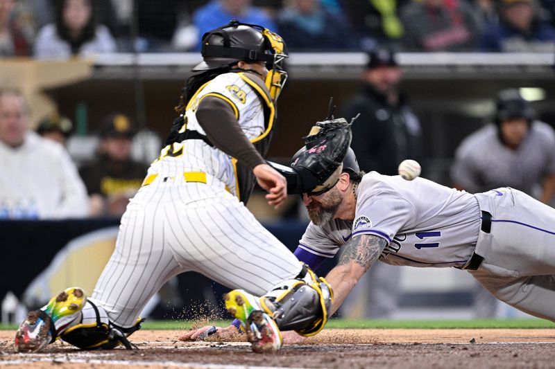 May 13, 2024; San Diego, California, USA; Colorado Rockies right fielder Jake Cave (11) dives home to score a run ahead of the throw to San Diego Padres catcher Luis Campusano (12) during the fourth inning at Petco Park. Mandatory Credit: Orlando Ramirez-USA TODAY Sports