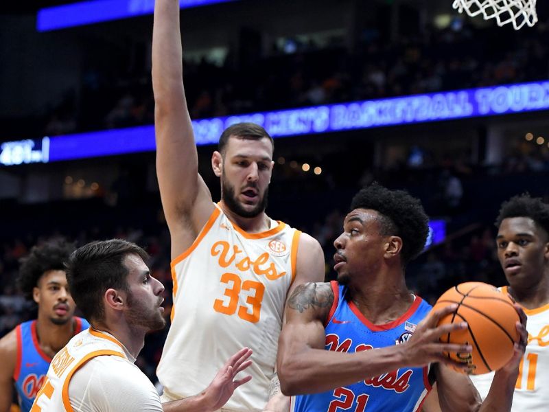 Mar 9, 2023; Nashville, TN, USA; Mississippi Rebels forward Robert Allen (21) tries to pass the ball as he is defended by Tennessee Volunteers forward Uros Plavsic (33) and guard Santiago Vescovi (25) during the second half at Bridgestone Arena. Mandatory Credit: Christopher Hanewinckel-USA TODAY Sports