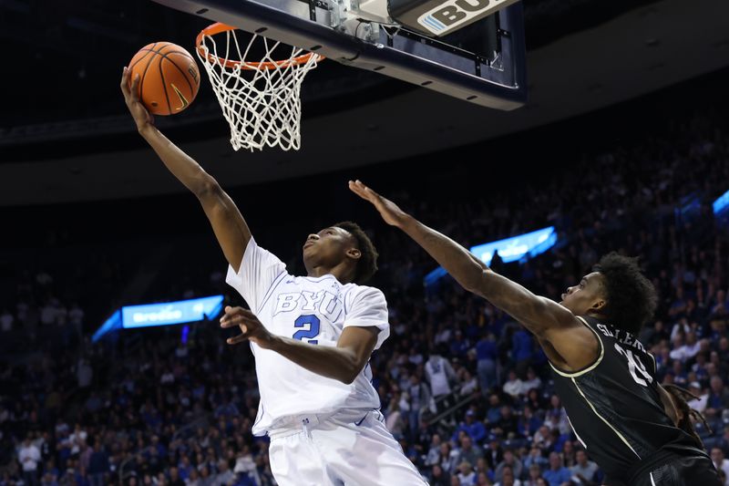 Feb 13, 2024; Provo, Utah, USA; Brigham Young Cougars guard Jaxson Robinson (2) lays the ball up past Central Florida Knights guard Jaylin Sellers (24) during the second half at Marriott Center. Mandatory Credit: Rob Gray-USA TODAY Sports