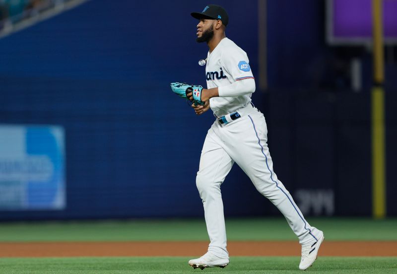 Jun 25, 2023; Miami, Florida, USA; Miami Marlins left fielder Bryan De La Cruz (14) runs on the field after winning the game against the Pittsburgh Pirates at loanDepot Park. Mandatory Credit: Sam Navarro-USA TODAY Sports