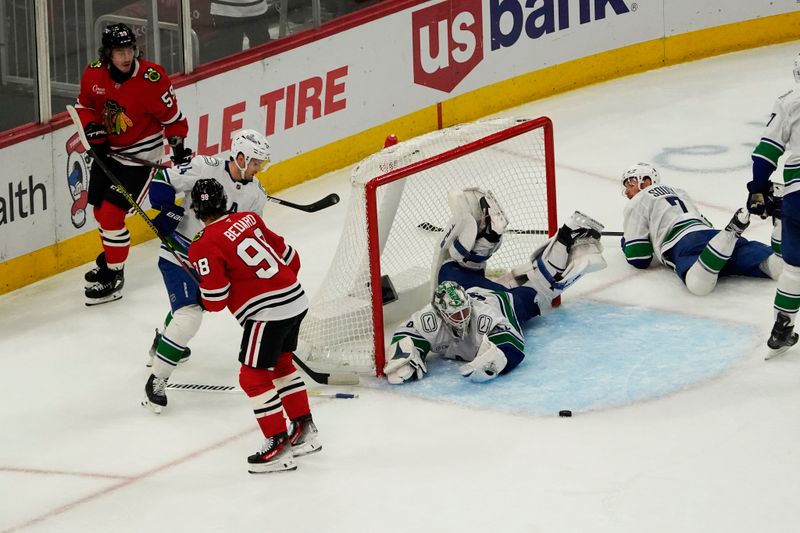 Oct 22, 2024; Chicago, Illinois, USA; Chicago Blackhawks left wing Tyler Bertuzzi (59) scores a goal on Vancouver Canucks goaltender Kevin Lankinen (32) during the third period at United Center. Mandatory Credit: David Banks-Imagn Images