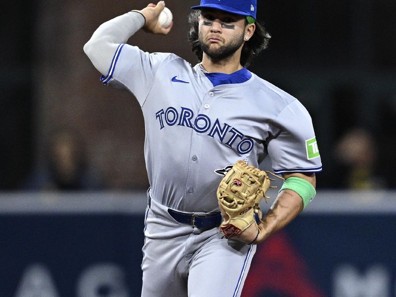 Apr 20, 2024; San Diego, California, USA; Toronto Blue Jays shortstop Bo Bichette (11) throws to first base during the eighth inning against the San Diego Padres at Petco Park. Mandatory Credit: Orlando Ramirez-USA TODAY Sports