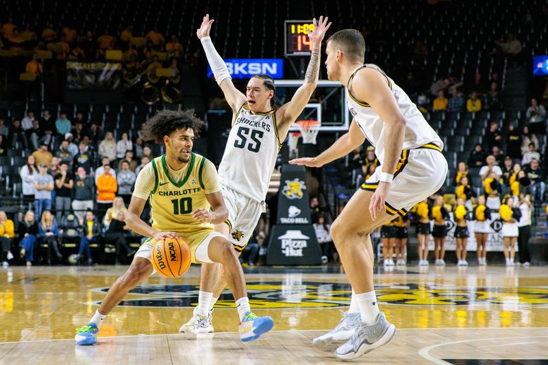 Jan 14, 2025; Wichita, Kansas, USA; Charlotte 49ers guard Nik Graves (10) drives around Wichita State Shockers guard Bijan Cortes (55) during the first half at Charles Koch Arena. Mandatory Credit: William Purnell-Imagn Images