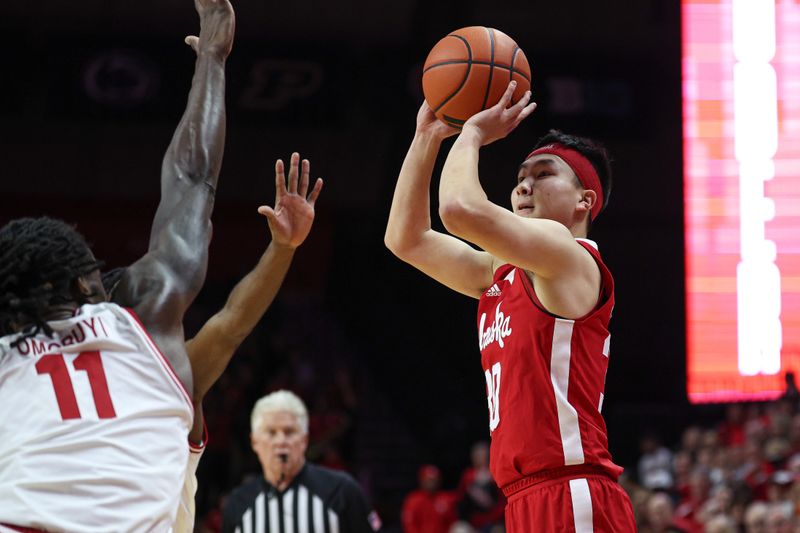 Jan 17, 2024; Piscataway, New Jersey, USA; Nebraska Cornhuskers guard Keisei Tominaga (30) shoots the ball asNebraska Cornhuskers guard Eli Rice (11) defends during the first half at Jersey Mike's Arena. Mandatory Credit: Vincent Carchietta-USA TODAY Sports