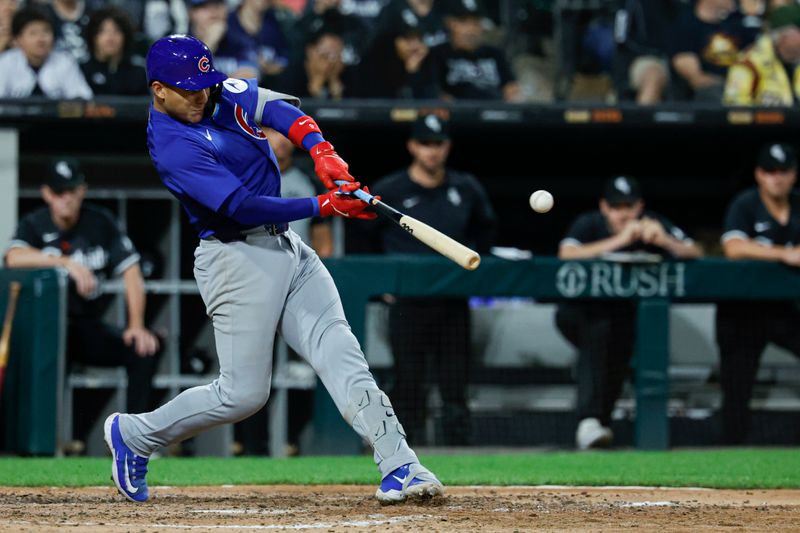 Aug 10, 2024; Chicago, Illinois, USA; Chicago Cubs catcher Miguel Amaya (9) hits a two-run single against the Chicago White Sox during the eight inning at Guaranteed Rate Field. Mandatory Credit: Kamil Krzaczynski-USA TODAY Sports