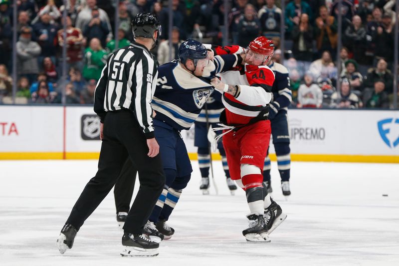 Mar 17, 2026; Columbus, Ohio, USA; Carolina Hurricanes left wing Nicolas Deslauriers (44) and Columbus Blue Jackets center Mathieu Olivier (24) fight during the second period at Nationwide Arena. Mandatory Credit: Russell LaBounty-Imagn Images