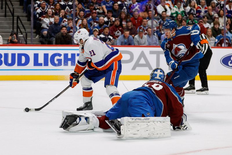 Oct 14, 2024; Denver, Colorado, USA; New York Islanders center Kyle Palmieri (21) controls the puck against Colorado Avalanche goaltender Alexandar Georgiev (40) and defenseman Josh Manson (42) in the first period at Ball Arena. Mandatory Credit: Isaiah J. Downing-Imagn Images