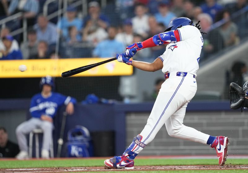 May 1, 2024; Toronto, Ontario, CAN; Toronto Blue Jays first base Vladimir Guerrero Jr. (27) hits a single against the Kansas City Royals during the first inning at Rogers Centre. Mandatory Credit: Nick Turchiaro-USA TODAY Sports