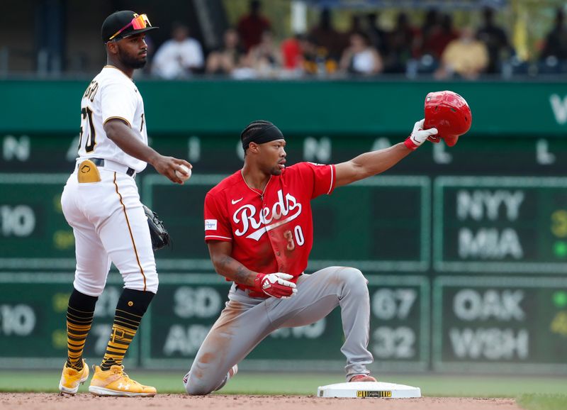 Aug 13, 2023; Pittsburgh, Pennsylvania, USA; Cincinnati Reds right fielder Will Benson (30) reacts after stealing second base as Pittsburgh Pirates shortstop Liover Peguero (60) looks on during the fifth inning at PNC Park. Mandatory Credit: Charles LeClaire-USA TODAY Sports