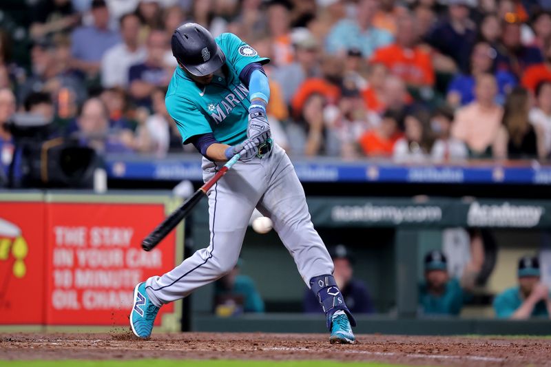 May 4, 2024; Houston, Texas, USA; Seattle Mariners second baseman Jorge Polanco (7) hits a single against the Houston Astros during the fifth inning at Minute Maid Park. Mandatory Credit: Erik Williams-USA TODAY Sports