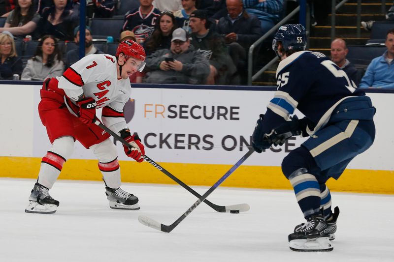 Apr 16, 2024; Columbus, Ohio, USA; Carolina Hurricanes defenseman Dmitry Orlov (7) looks to shoot as Columbus Blue Jackets defenseman David Jiricek (55) defends during the first period at Nationwide Arena. Mandatory Credit: Russell LaBounty-USA TODAY Sports