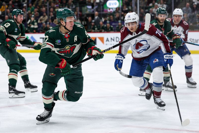 Nov 28, 2025; Saint Paul, Minnesota, USA; Minnesota Wild left wing Kirill Kaprizov (97) and Colorado Avalanche defenseman Sam Malinski (70) compete for the puck during the second period at Grand Casino Arena. Mandatory Credit: Matt Krohn-Imagn Images