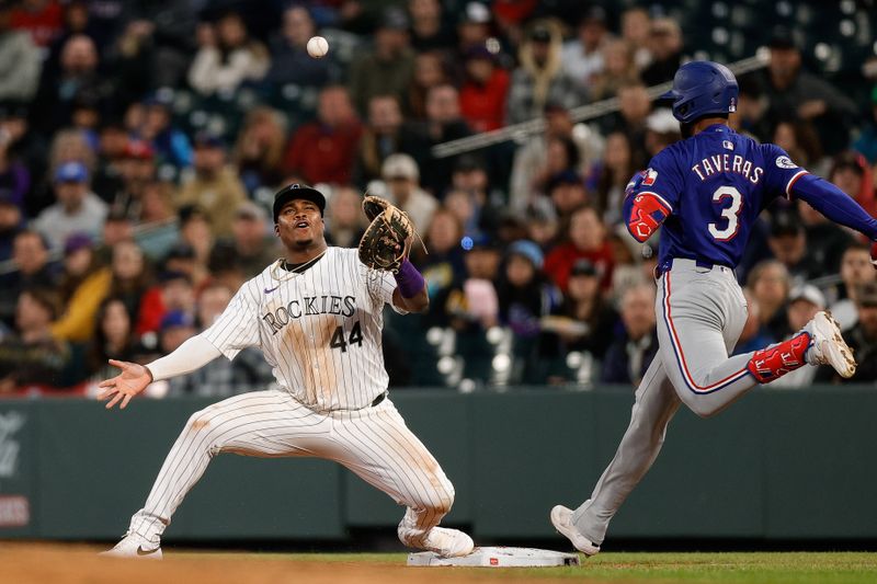 May 10, 2024; Denver, Colorado, USA; Texas Rangers center fielder Leody Taveras (3) safely reaches first as Colorado Rockies first baseman Elehuris Montero (44) is unable to field a throw in the seventh inning at Coors Field. Mandatory Credit: Isaiah J. Downing-USA TODAY Sports