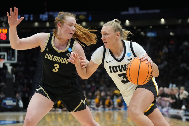 Mar 24, 2023; Seattle, WA, USA; Iowa Hawkeyes guard Sydney Affolter (right) dribbles the ball against Colorado Buffaloes guard Frida Formann in the first half at Climate Pledge Arena. Mandatory Credit: Kirby Lee-USA TODAY Sports