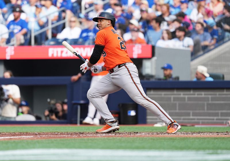 Sep 13, 2025; Toronto, Ontario, CAN; Baltimore Orioles catcher Samuel Basallo (29) hits an RBI double against the Toronto Blue Jays during the eighth inning at Rogers Centre. Mandatory Credit: Nick Turchiaro-Imagn Images