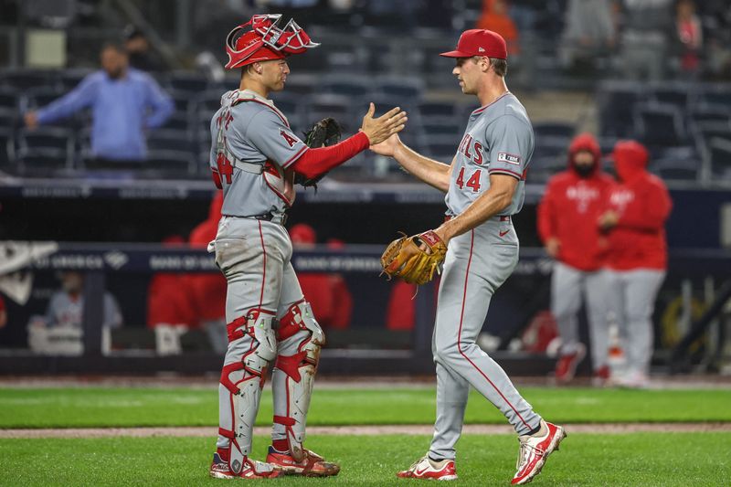 Aug 8, 2024; Bronx, New York, USA;  Los Angeles Angels catcher Logan O'Hoppe (14) and relief pitcher Ben Joyce (44) celebrate after defeating the New York Yankees 9-4 at Yankee Stadium. Mandatory Credit: Wendell Cruz-USA TODAY Sports