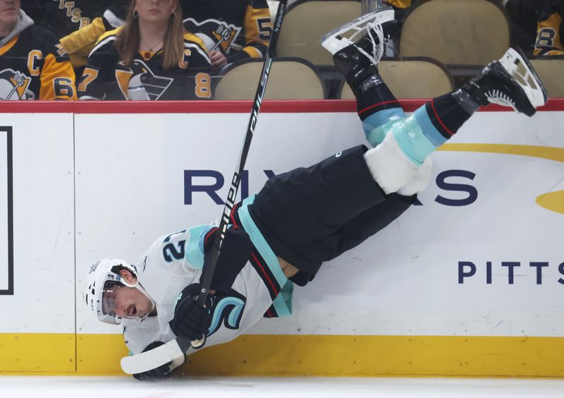 Nov 22, 2025; Pittsburgh, Pennsylvania, USA; Seattle Kraken left wing Mason Marchment (27) loses his balance while celebrating after scoring a goal against the Pittsburgh Penguins during the second period at PPG Paints Arena. Mandatory Credit: Charles LeClaire-Imagn Images