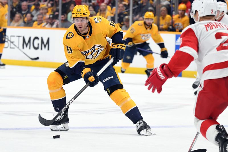 Mar 23, 2024; Nashville, Tennessee, USA; Nashville Predators center Colton Sissons (10) skates the puck into the offensive zone during the first period against the Detroit Red Wings at Bridgestone Arena. Mandatory Credit: Christopher Hanewinckel-USA TODAY Sports