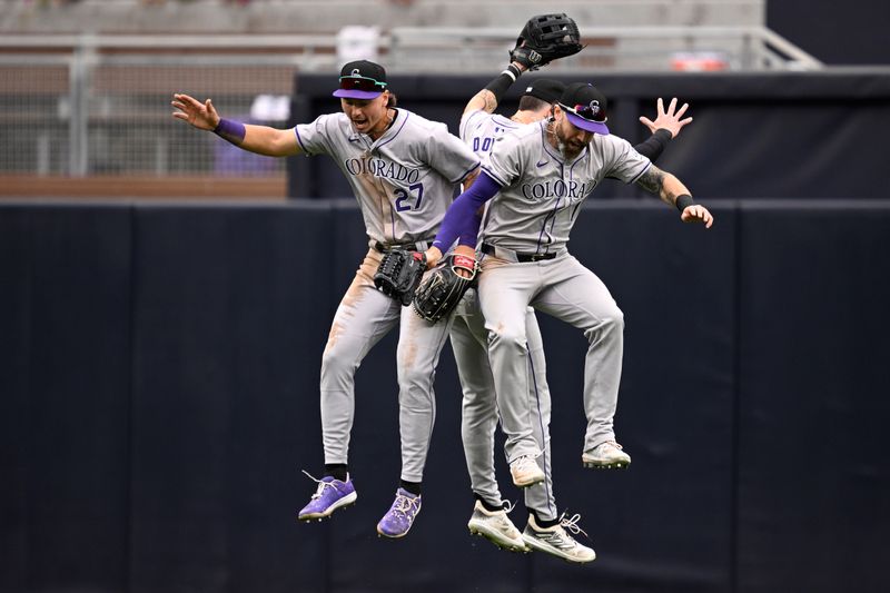 May 15, 2024; San Diego, California, USA; Colorado Rockies left fielder Jordan Beck (27) celebrates with center fielder Brenton Doyle (9) and right fielder Jake Cave (11) after defeating the San Diego Padres at Petco Park. Mandatory Credit: Orlando Ramirez-USA TODAY Sports