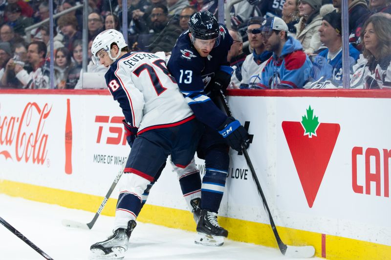 Jan 9, 2024; Winnipeg, Manitoba, CAN; Columbus Blue Jackets defenseman Damon Severson (78) boards Winnipeg Jets forward Gabriel Vilardi (13) during the second period at Canada Life Centre. Mandatory Credit: Terrence Lee-USA TODAY Sports